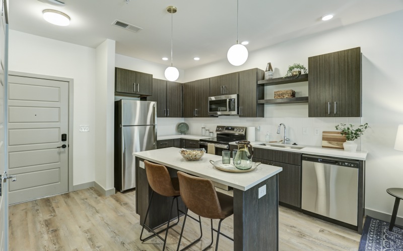 Apartment kitchen with island and brown cabinets