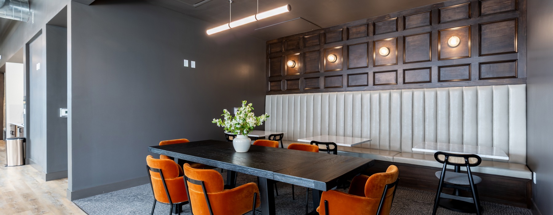 Table with orange chairs and lights