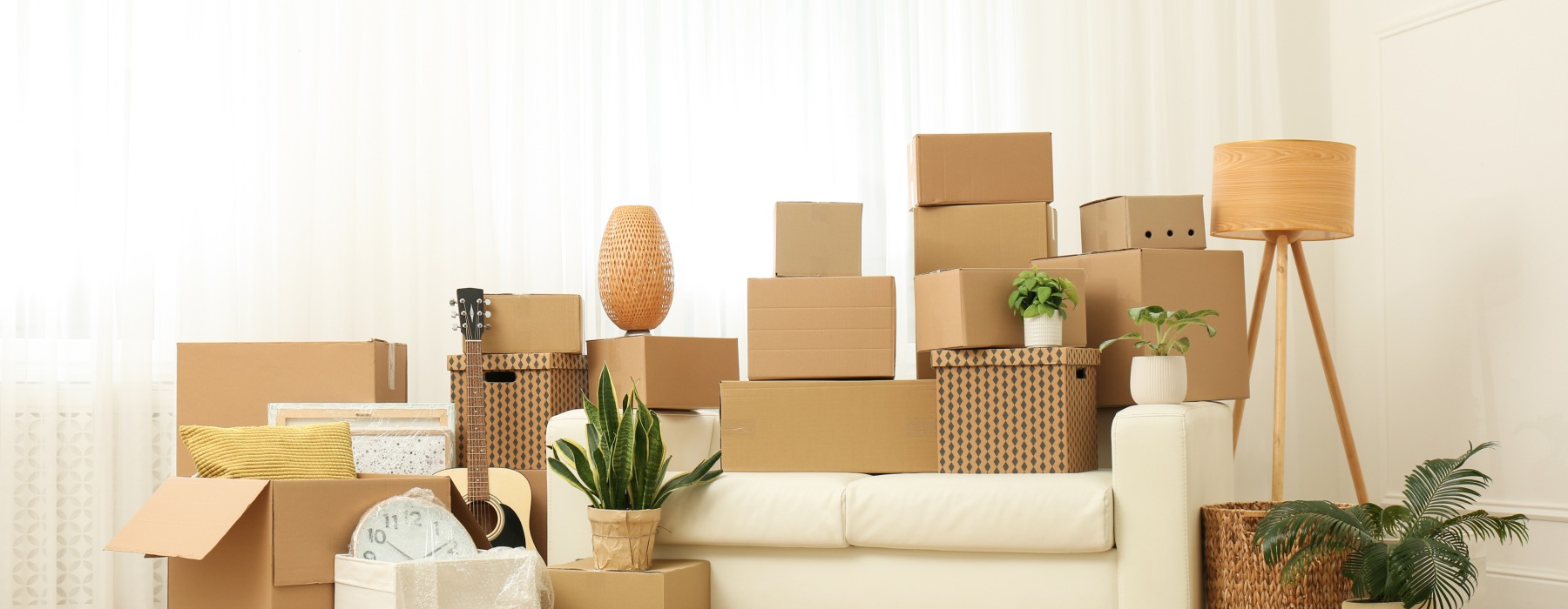 A bunch of moving boxes around sofa