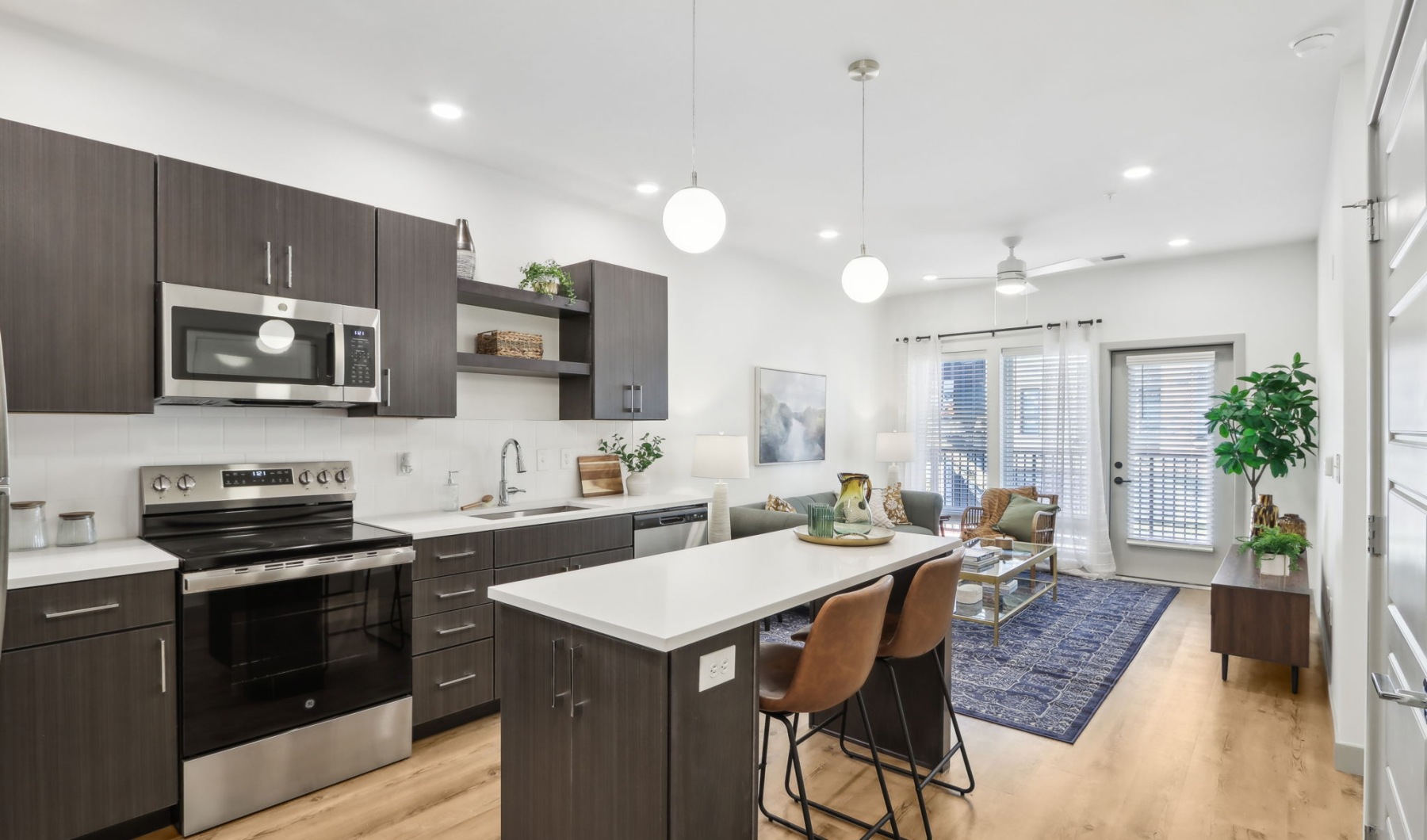 Styled apartment kitchen with brown cabinets