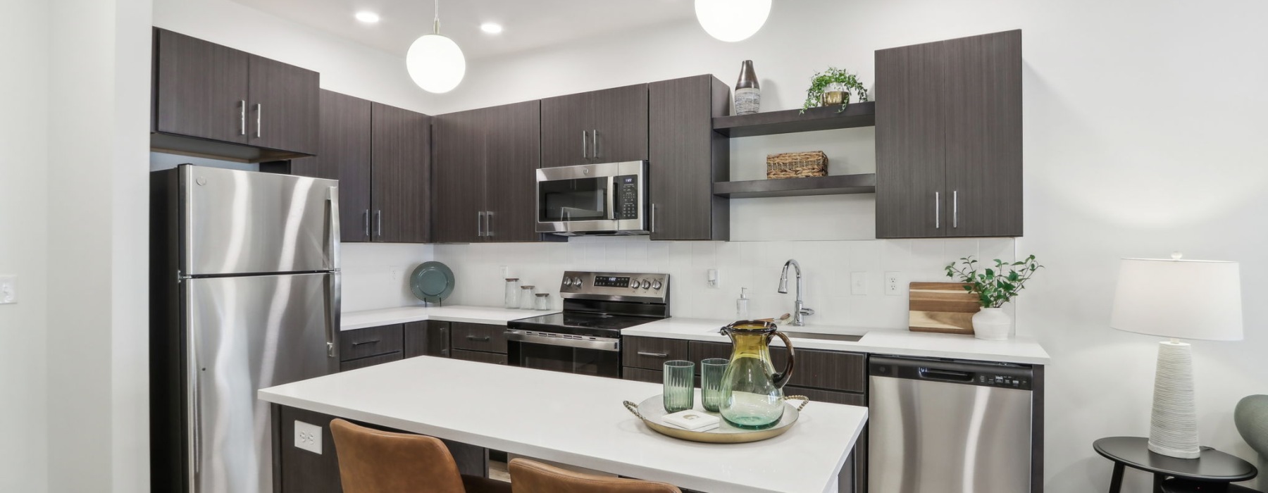 Styled apartment kitchen with pendant lights