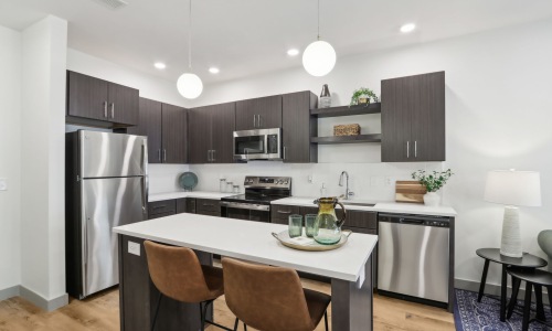 Whip up a meal in your modern kitchen Styled apartment kitchen with pendant lights
