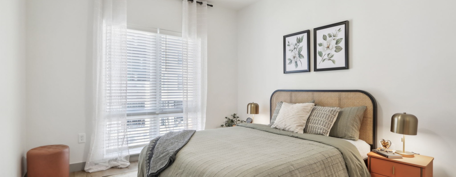 Styled apartment bedroom with ceiling fan