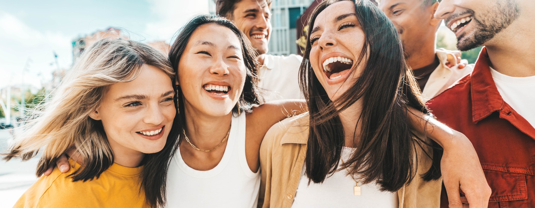 A group of diverse friends laughing in the city